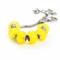 Yellow glass charm bracelet with silver snake chain, glowing luminous faceted beads for women. - 9*14mm / A Yellow