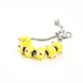 Silver snake chain charm bracelet with yellow glass beads featuring white and red flower patterns. - A Yellow