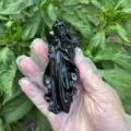 Detailed view of a carved black obsidian crystal angel cupid figurine for home decor and healing. - Obsidian / 10cm Size