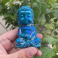 Detail shot of blue aura crystal carved buddha figurine, showing sparkling shiny gemstone surface. - Electroplated Light Blue
