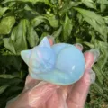 Detail shot of a polished crystal sleeping cat figurine showcasing its smooth opalite texture. - Opal / Standard Weight