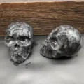 Natural stone carved skull crystal ornament, 7cm gothic home decor, polished gemstone healing. - Larvikite