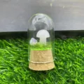 Crystal mushroom glass terrarium detail shot showing delicate stone carving and miniature green landscape. - White Jade