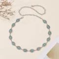 Detail shot of vintage silver metal waist chain with turquoise stones and carved flower discs. - Turquoise