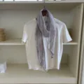 Detailed view of the retro grey narrow linen scarf draped on a white tee inside a neat shelf. - Light Purple