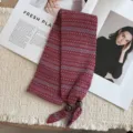 Close-up detail of knit mini scarf with red and blue jacquard pattern and wooden beads. - 20_Fair Isle Burgundy