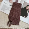 Detail shot of retro knitted neck warmer with textured jacquard pattern and bead fringe ends. - 21_Fair Isle