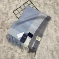 Soft blue grey plaid wool winter scarf with classic fringe detail for cozy daily wear. - Light Blue Plaid