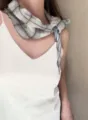 Detailed view of a Japanese vintage plaid scarf tied elegantly around the neck, lightweight. - 1_Grey