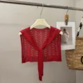 Detail view of red knit hollow shawl, lightweight summer capelet with tie front design. - Brick Red