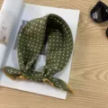 Details of vintage green cotton polka dot headscarf styled with magazine and sunglasses. - Olive Green Polka Dot