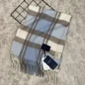 Detailed view of luxury 100% Australian wool plaid scarf with cozy fringe and classic pattern. - Light Lake Blue Plaid