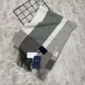 Detailed view of cozy wool plaid scarf texture, elegant fringe detail, and product tags. - Light Green Large Striped