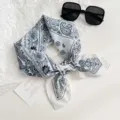 Black and white paisley print scarf detail, vintage bandana closeup showing soft fabric texture. - Paisley Floral / White