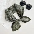 Detailed close-up of the dark green paisley bandana, showing soft fabric texture and patterns. - Paisley Floral / Green