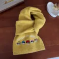 Yellow knitted winter warm wool blend scarf with cute cartoon embroidery and stylish text. - Ginger Yellow