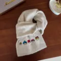Beige knit scarf with cute embroidered cartoon faces, warm and thick winter accessory for women. - Apricot