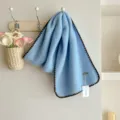 Cozy light blue winter scarf with contrast dark edges, soft knitted style for women. - Blue