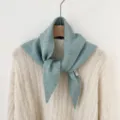 Close-up detail of a soft blue-green knitted triangular scarf, woolen warm winter neck wrap. - Blue Triangular Scarves