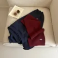 Burgundy knit scarf and navy sweatshirt detailed view, retro cozy winter fashion apparel item. - Cherry
