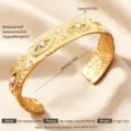 Breites Edelstahl Manschettenarmband mit dem bösen Blick und funkelnden Strasskristallen. - Gold Böser Blick