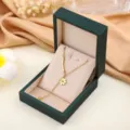 Gold titanium steel necklace with flower pendant and curved bar in green jewelry box SKU - Gold