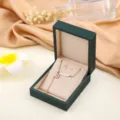 Rose gold stainless steel necklace with flower and curved bar pendant in gift box. - Rose Gold