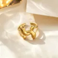 Trendy golden titanium steel open ring with unique puffy design, adjustable size for women. - Cross U-Shape Style / Gold