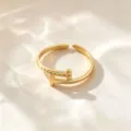 Anillo abierto de acero de titanio dorado, diseño geométrico minimalista en T y cuentas. - Anillo en T / Dorado