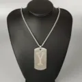 Stainless steel letter pendant necklace detail, silver cutout Y dog tag chain jewelry closeup. - Letter Y