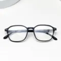 Detail view of lightweight TR90 optical glasses frame, clear lens display, flexible temples. - Matte Black