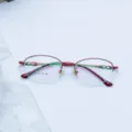 Detailed shot of red metal semi-rimless optical glasses frame with stylish ring temple design. - Red / Plain