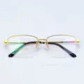 Close-up detail of luxury gold semi-rimless business glasses frame with clear size mark. - Bright Gold