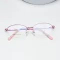 Close-up detail showing the pink semi-rimless oval metal eyeglass frame structure. - Pink