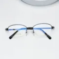 Metal half-rim oval eyeglasses frame detail showing frame structure and lens size. - Bright Black