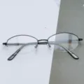 Detailed view of women's oval half-rim optical metal glasses frame in black, model 3056. - Bright Black / Plain