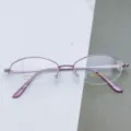 Detail view of pink metal half-rim optical glasses frame, model 3056, elegant and lightweight. - Light Purple / Plain