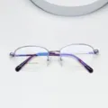 Detailed view of oval purple metal half-frame optical glasses with slim temples. - Purple