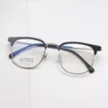 Close-up detail of the vintage browline eyeglass frame, highlighting titanium and TR temples. - Black & Gold