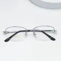 Detail view of women's titanium alloy semi-rimless oval eyeglass frame with flexible temples. - Silver White