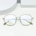 Close-up detail of vintage polygon metal eyeglass frames, lightweight titanium glasses. - Black & Gold
