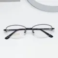 Detailed view of women's semi-rimless titanium eyeglass frames with oval shape and flexible temples. - Bright Black