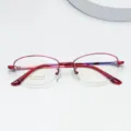 Close-up detail of red semi-rimless titanium eyeglass frame, lightweight & stylish. - Burgundy