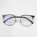Close-up of titanium browline eyeglasses frame, detailed view of metal hinge and rim structure. - Black Silver