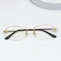 Detailed view of semi-rimless titanium eyeglasses frame, elegant oval design for women. - Bright Gold
