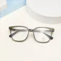 Close-up detail of stylish square TR90 anti-blue light optical glasses frame in translucent gray. - Olive Green