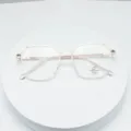 Detailed view of trendy polygonal clear frame glasses with thin metal temples for stylish daily wear. - Clear White