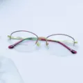 Detailed view of women business metal semi-rimless optical glasses frame in gold. - Purple Edges with Gold Frame