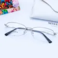 Women's half-rim metal optical glasses frame with memory temples. Clear detail view of frame. - White