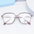 Clear anti-blue light glasses close-up, retro polygonal TR90 optical frame detail view. - Brown